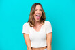 © luismolinero - Young caucasian woman isolated on blue background shouting to the front with mouth wide open