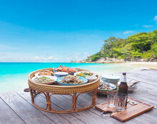Thai Seafood Set Served On Bamboo Tray On Wooden Floor Over Summer Beach Background