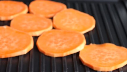Wall Mural - Fry a slice of sweet potato on an electric grill. grilled vegan food