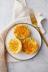 Poster - Savory muffins with egg, feta cheese, cheddar and spinach on light background