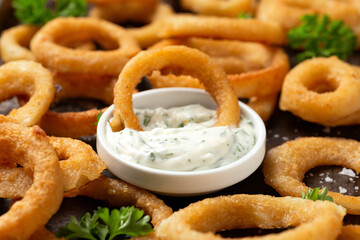 Wall Mural - Crunchy Fried Battered onion rings with garlic sauce