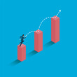 © pishit - Ambition concept with businessman jumping on graph columns
