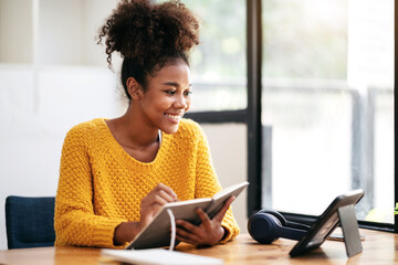 Wall Mural - African american student woman in sweater watching e-learning to