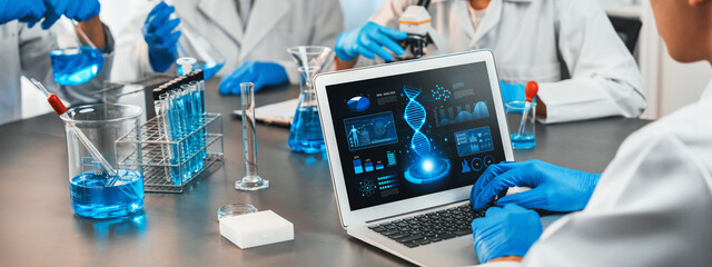 Dedicated scientist group working on advance biotechnology computer software to study or analyze DNA data after making scientific breakthrough from chemical experiment on medical laboratory. Neoteric