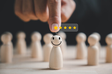 Selecting a happy face wooden figure for success. Customer service rating, feedback, and satisfaction survey. HR management choosing a positive attitude in team leadership. Human Resource Management