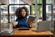 © Wasana - Young black woman resting mood with coffee and reading report.