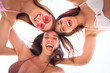 © CarlosBarquero - Group of three beautiful excited girls posing in circle for mobile selfie on summer vacation day. Happy young pretty women hugging looking down funny in bikini. Generation z and friendly relationships