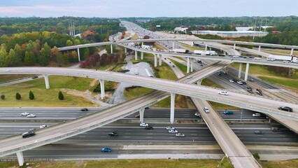 Poster - American freeway intersection with fast driving cars and trucks. View from above of USA transportation infrastructure