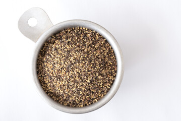 Wall Mural - GrouGround Black Pepper in a Measuring Cupnd Black Pepper in a Measuring Cup