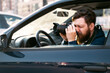 © phoenix021 - Man paparazzo taking pictures from the car, closeup shot . Private investigator