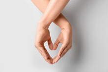 Woman Making Heart With Her Hands On Grey Background