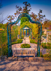 Wall Mural - Wooden sit under a metal frame in botanical garden of Essen town. Marvelous outdoor scene of Germany, Europe. Beauty of nature concept background.