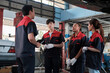 © tigercat_lpg - Male expert supervisor engineer train and discuss with professional mechanic worker teams, inspect repair work at car service garage, harmonious group, and do maintenance jobs in automotive industry.
