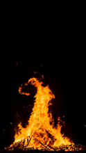Big Bonfire On The Beach At Night With Beautiful Forms On The Flames