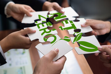 Cohesive group of business people forming jigsaw puzzle pieces in net zero icon symbol as eco corporate responsibility to reduce CO2 emission as sustainable solution for greener Earth. Quaint