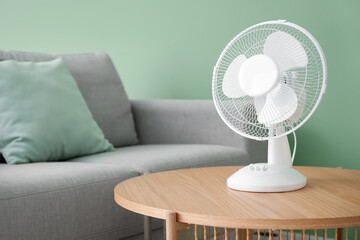 Canvas Print - Wooden table with modern electric fan in interior of living room