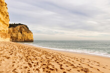 Footprints In The Sand On A Beach In Southern Portugal On The Seven Hanging Valleys Trail On A Sunny Winter Day.