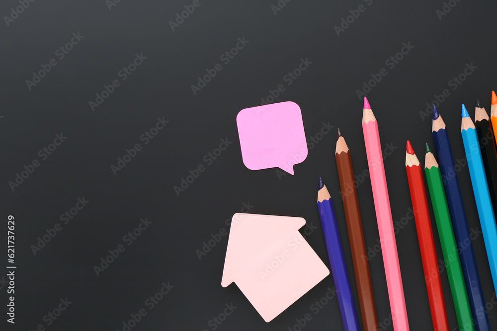 Different stationery on black chalkboard