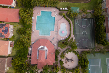 Wall Mural - A swimming pool with a red roof and palms