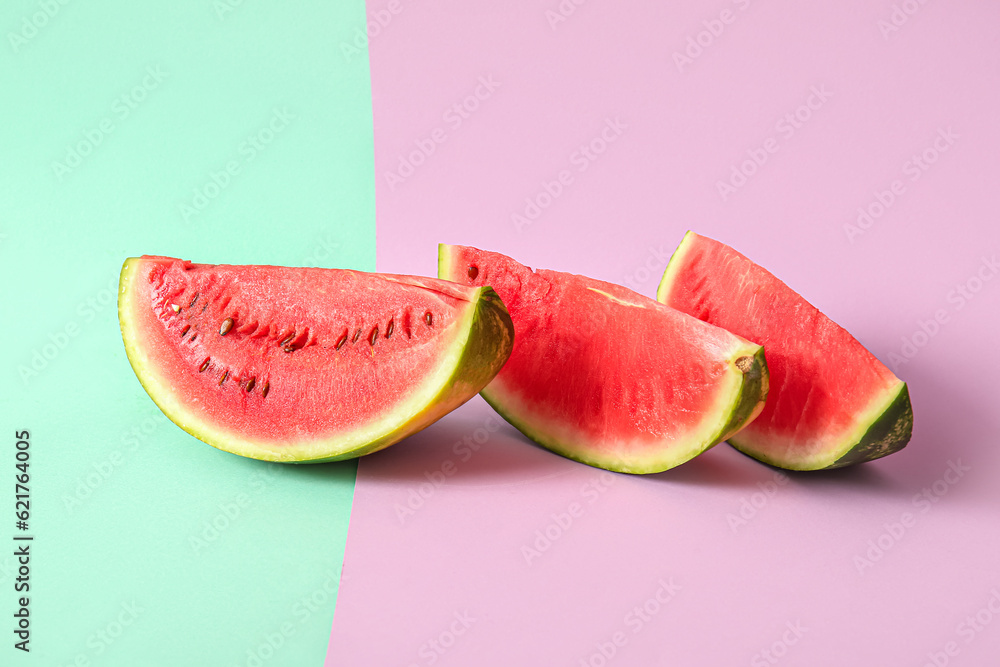 Pieces of fresh watermelon on colorful background