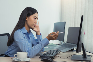 Wall Mural - stress asian woman while coding data programmer on desktop pc while working on computer codes in the