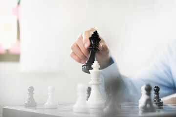 Wall Mural - hand of businessmen moving chess in competition shows leadership, followers, and business success strategies