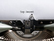 The word top secret written with a vintage typewriter. Confidential classified document, secrecy and information concept.