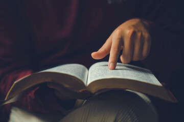 Wall Mural - Christian man's hands while reading the Bible outside.Sunday readings, Bible education. spirituality and religion concept. Reading a book.education learning