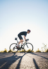 Mountain, fitness and man athlete on bicycle cycling training for a race or marathon in nature. Sports, workout and male cyclist riding a bike for cardio exercise on an outdoor off road trail.