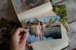 Photo printing service concept. Person looks at printed photos in photo album.
