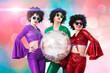 Group of funky girls holding a disco ball, halloween party, on a pink background.