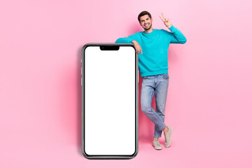 Canvas Print - Full size photo of handsome young guy beaming smile show v-sign vertical banner wear trendy blue clothes isolated on pink color background