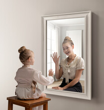 Creative Conceptual Collage. Little Girl Looking In Mirror And Seeing Reflection Of Young Girl. Greeting Her Future Self. Concept Of Present, Past And Future, Age, Lifestyle, Generation, Ad