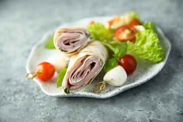 Wall Mural - Ham and cream cheese rolls served with vegetables