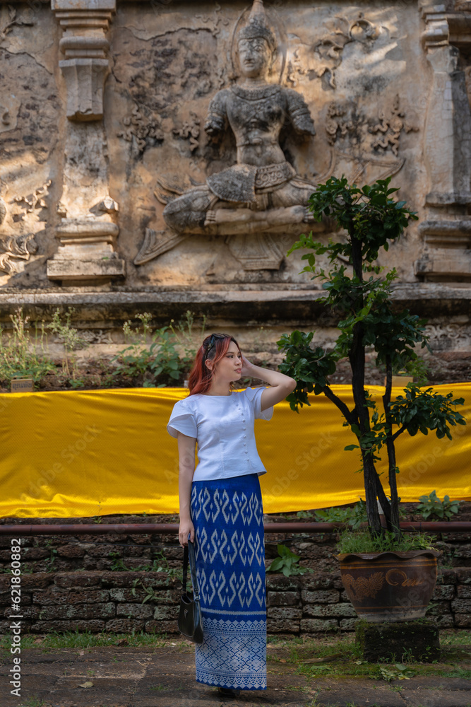 Pretty Asian tourists woman wearing beautiful hand-woven clothes dyed with  indigo and mud-fermented natural colors modern Thai traditional dress  costumes are popular in ancient temple Thailand. Stock Photo | Adobe Stock