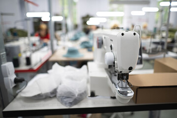 Wall Mural - workers in an industrial garment factory sew clothes on sewing machine