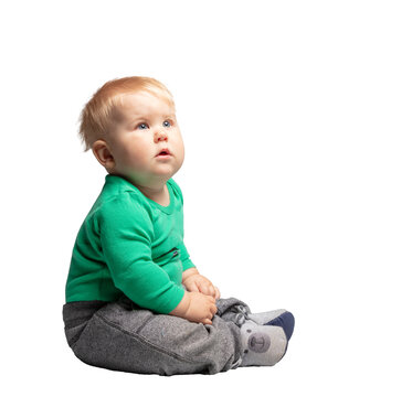 Wall Mural -  - Toddler, a boy sitting and looking at copy space. Isolated on transparent white background