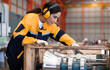 © Nassorn - Female industrial engineer in safety jacket work in heavy metal production engineering factory. Latin technician woman wearing headphone working in metalwork manufacturing and warehouse facility.