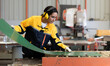 © Nassorn - Female industrial engineer in safety jacket work in heavy metal production engineering factory. Latin technician woman wearing headphone working in metalwork manufacturing and warehouse facility.