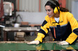 © Nassorn - Female industrial engineer in safety jacket work in heavy metal production engineering factory. Latin technician woman wearing headphone working in metalwork manufacturing and warehouse facility.
