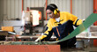 © Nassorn - Female industrial engineer in safety jacket work in heavy metal production engineering factory. Latin technician woman wearing headphone working in metalwork manufacturing and warehouse facility.