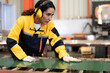 © Nassorn - Female industrial engineer in safety jacket work in heavy metal production engineering factory. Latin technician woman wearing headphone working in metalwork manufacturing and warehouse facility.