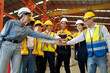 © Nassorn - Group of diverse workers standing together in storehouse holding hands. Multicultural team working in logistic distribution warehouse Latino, Caucasian and Asian people in manufacturing industrial.