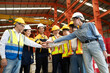 © Nassorn - Group of diverse workers standing together in storehouse holding hands. Multicultural team working in logistic distribution warehouse Latino, Caucasian and Asian people in manufacturing industrial.