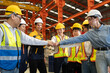 © Nassorn - Group of diverse workers standing together in storehouse holding hands. Multicultural team working in logistic distribution warehouse Latino, Caucasian and Asian people in manufacturing industrial.