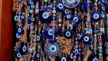 A Lot Of Key Rings And Pendants, Bracelets With A Blue Eye, Amulets, Beads From The Evil Eye In The Souvenir Shop Of The Turkish City