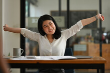 Portrait Image Of Young Asian Businesswoman Or Female Office Worker Spreading Her Arms Out In A Refreshing Way, Breaks During Office Work.