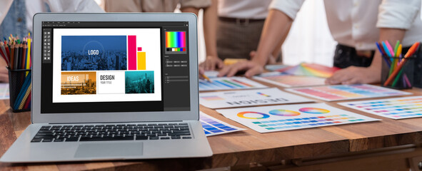 Poster - Panorama focus view of laptop display digital art workspace for graphic designer with blurred background of graphic team brainstorm and working on testing color palette for unique design. Scrutinize