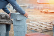 Bricklayer laying high-density footing concrete blocks