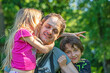© Nataliia Makarovska - little girl daughter hugs and kisses dad on one side and a boy son on the other. father's day. Family holiday